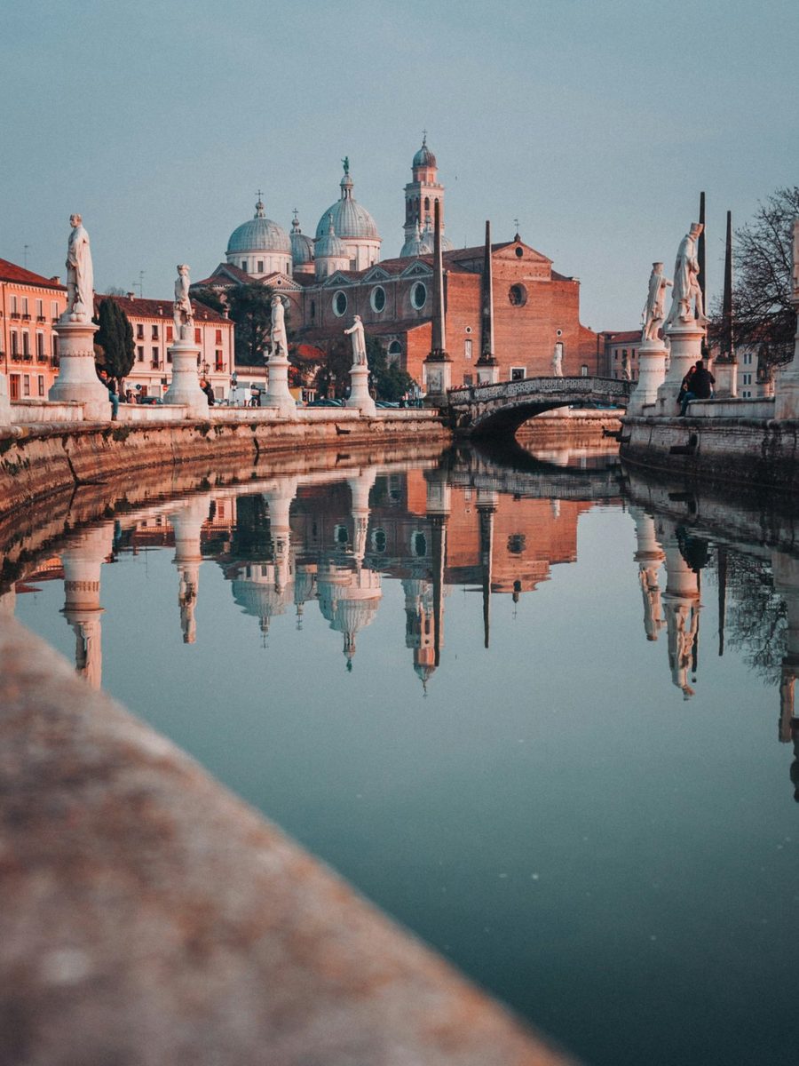 Prato della Valle in Padova, its statues and the basilica of Santa Giustina reflected in the canal