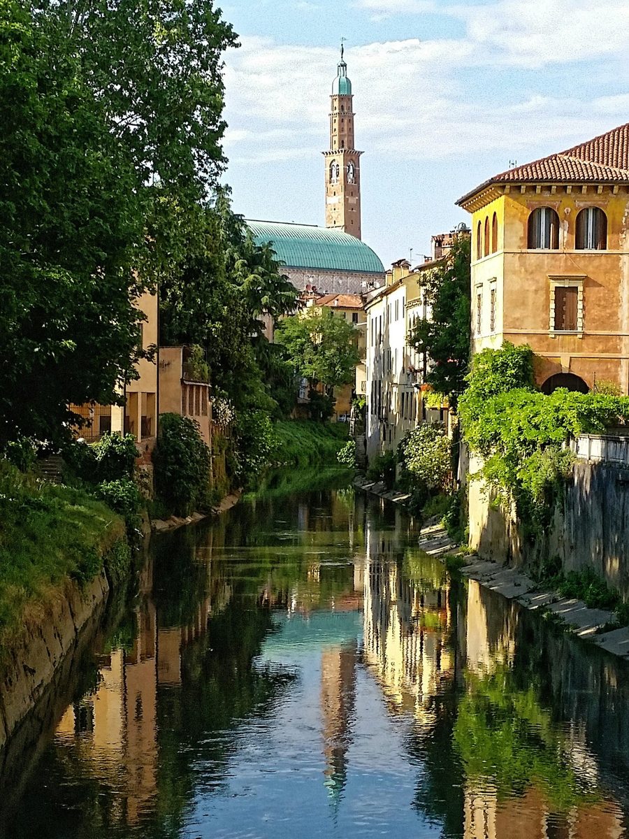 The Retrone river in Vicenza, with the dome and tower of the Basilica Palladiana